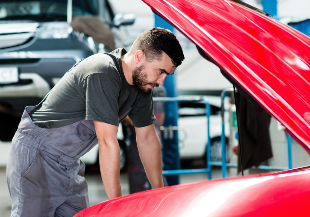 auto-mechanic-working-in-garage-repair-service-looking-at-the-car-s-motor-image.jpg