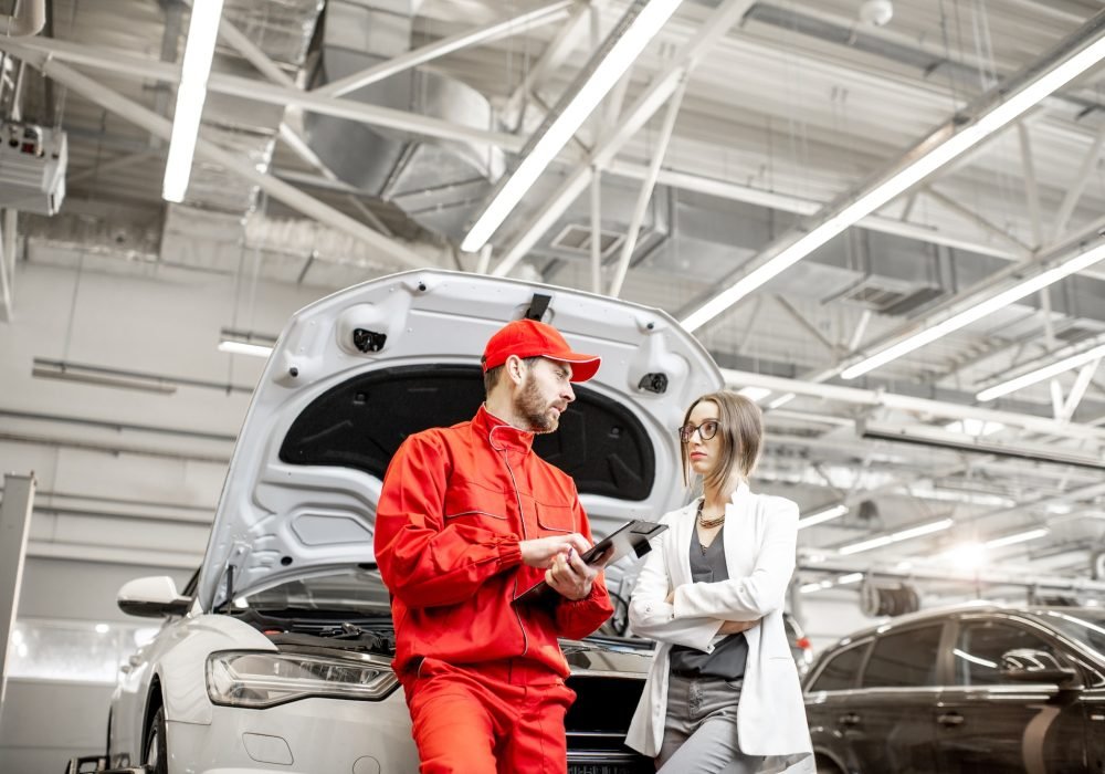 woman-client-with-auto-mechanic-at-the-car-service.jpg